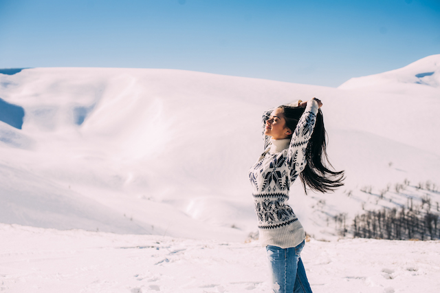 beautiful girl enjoying the sun, winter day in the mountains