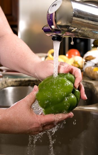 washing-a-green-bell-pepper-under-some-fresh-running-tap-water-347x544